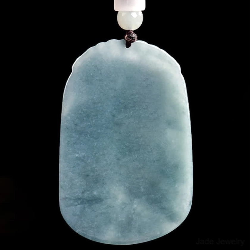 Reverse uncarved side of double koi jade pendant showing smooth polished natural blue-grey jade surface and necklace attachment, authentic jade craftsmanship proof