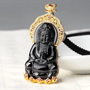 Guanyin pendant three-quarter angle with attached black woven cord and intricate gold bail detail