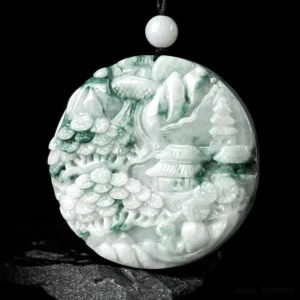 Hand-carved jade landscape pendant with detailed mountain pavilion and waterscape relief carving, paired with black braided cord and white jade spacer beads