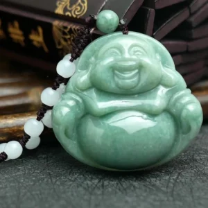 Laughing Buddha jade pendant necklace with white jade beads and traditional brown waxed cord displayed on dark slate with Asian calligraphy backdrop