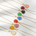 Multi-color Laughing Buddha jade necklaces with 18K gold filled chains displayed in flat lay overhead view, showing various jade color options including green, white, pink, red, and blue with rhinestone accents