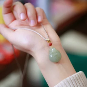 Woman wearing Hetian jade Laughing Buddha necklace on wrist, braided cord with adjustable design