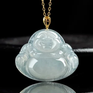 Laughing Buddha natural jade pendant close-up front view on black display, showing detailed carved smiling Buddha face with translucent light green jade and gold-tone metal bail