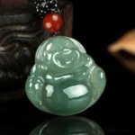 Laughing Buddha jade pendant front close-up with hand-carved facial features on black beaded cord with red accent bead