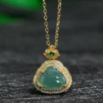 Laughing Buddha jade pendant necklace with gold plating and cubic zirconia halo, front view