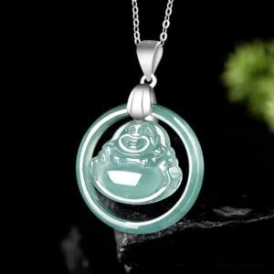 Laughing Buddha jade necklace three-quarter overhead view with light teal jadeite floating pendant display against green foliage