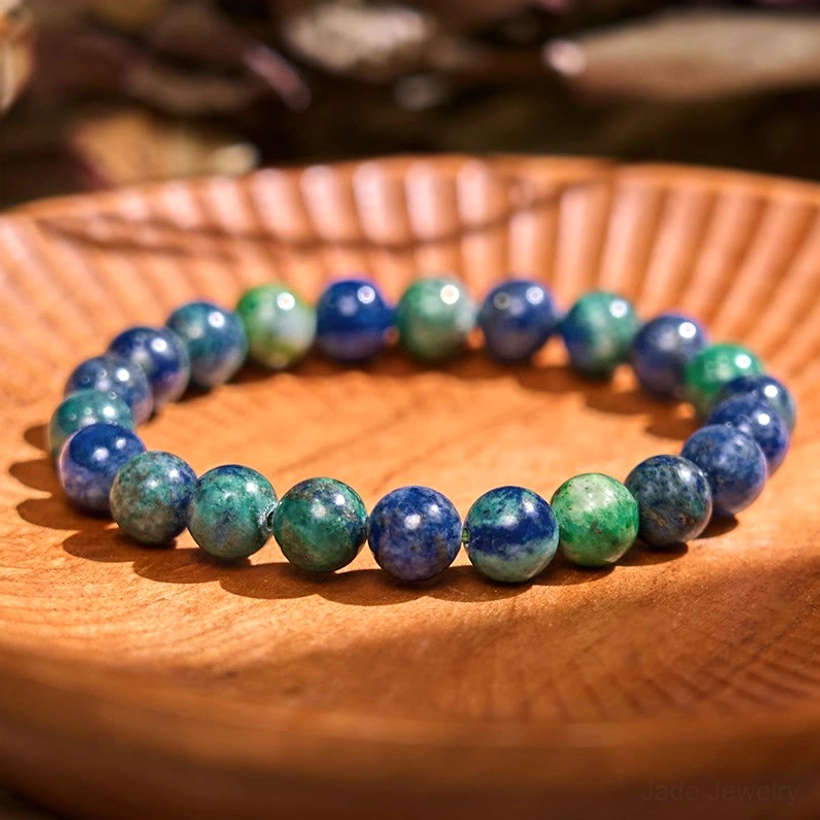 Lazurite stone balance bracelet, flat lay display on neutral background showing polished round blue-purple gemstone beads