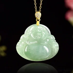 Light green jade laughing Buddha necklace pendant on black reflective background showing smooth carved Maitreya Buddha design with gold-toned micro-zirconia bail and hardware detail