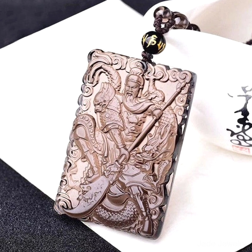 Lord Guan jade pendant necklace lifestyle photo showcasing spiritual protection and wealth attraction symbolic jewelry piece in contemporary context