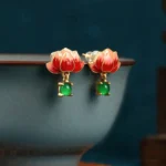 Red lotus enamel gold jade dangle earrings with green jade pendant, detailed side close-up view showcasing cloisonné craftsmanship