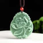 Hand-carved lotus jade pendant necklace in front view, displaying detailed floral engraving on dark green natural jade with brown hemp cord and red accent bead - prosperity and spiritual growth symbol