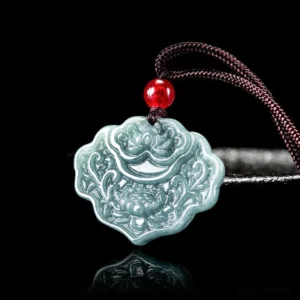 Celadon jade lotus carved pendant necklace with brown cord and red bead on reflective dark background