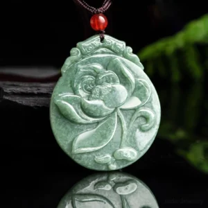 Overhead close-up detail view of hand-carved lotus jade pendant showing intricate lotus flower engraving and natural jade surface with mirrored reflection detail