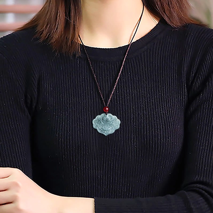 Woman wearing celadon lotus jade pendant necklace on brown cord as everyday jewelry