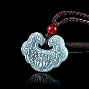 Lotus ruyi jade pendant necklace top-down view showing intricate carved cloud motifs and brown cord with red bead accent