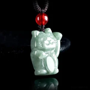 Maneki Neko jade lucky cat pendant rear three-quarter angle, showing smooth jade back with oval chest carving and red-black cord