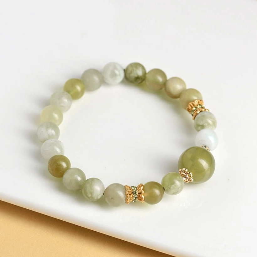 Minimalist green jade prosperity bracelet with uniform bead size and gold accents