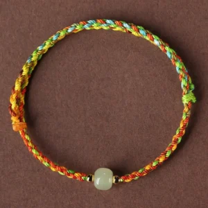 Multicolor braided jade bead bracelet top view with light green jade centerpiece and metal spacers