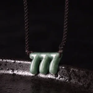 Green jade 777 angel number pendant necklace close-up top view showing carved triple seven charm with dark brown hand-braided adjustable cord