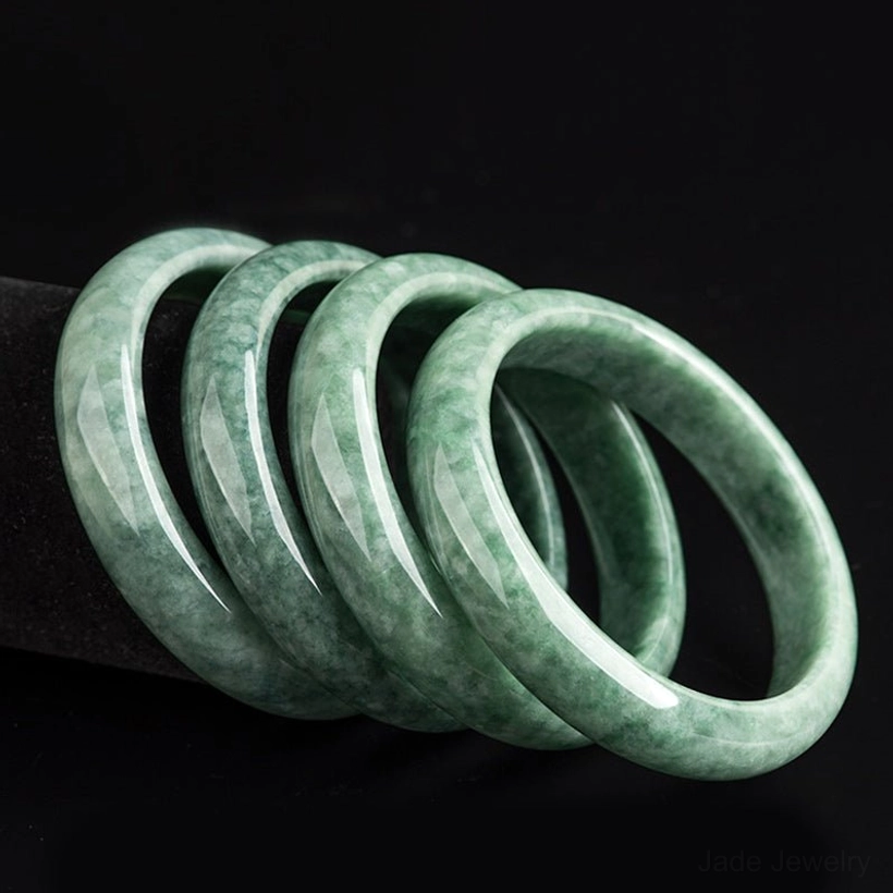 Natural green jade bangle bracelet size comparison and variety display showing available diameter options