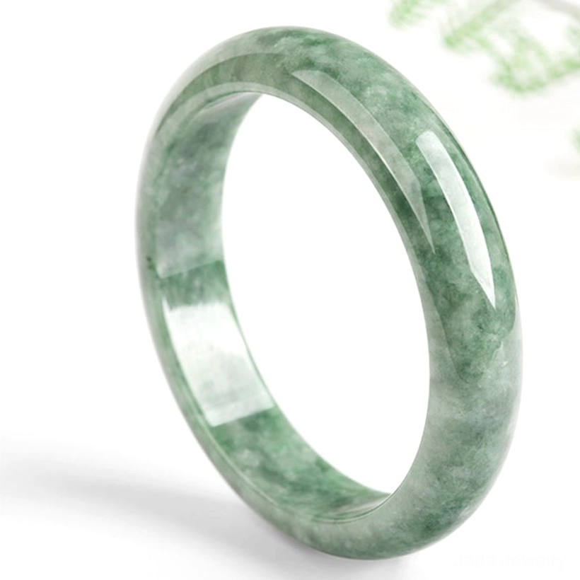 Solid natural jade bangle bracelet on white background, left three-quarter view showing authentic green marbled surface
