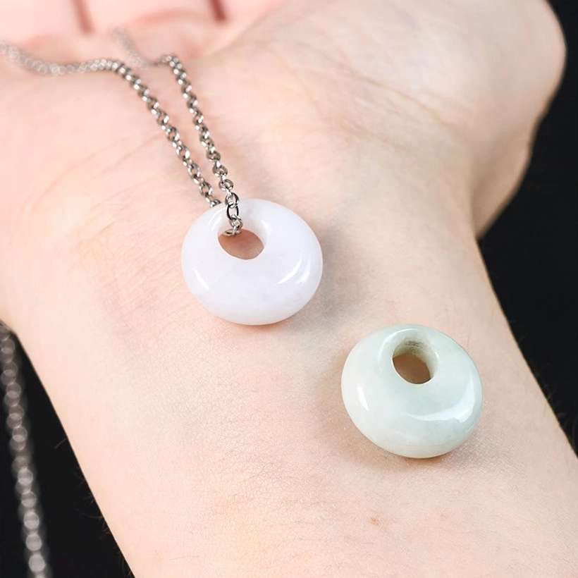 Natural jade donut pendant on delicate chain showing minimalist jewelry style aesthetic
