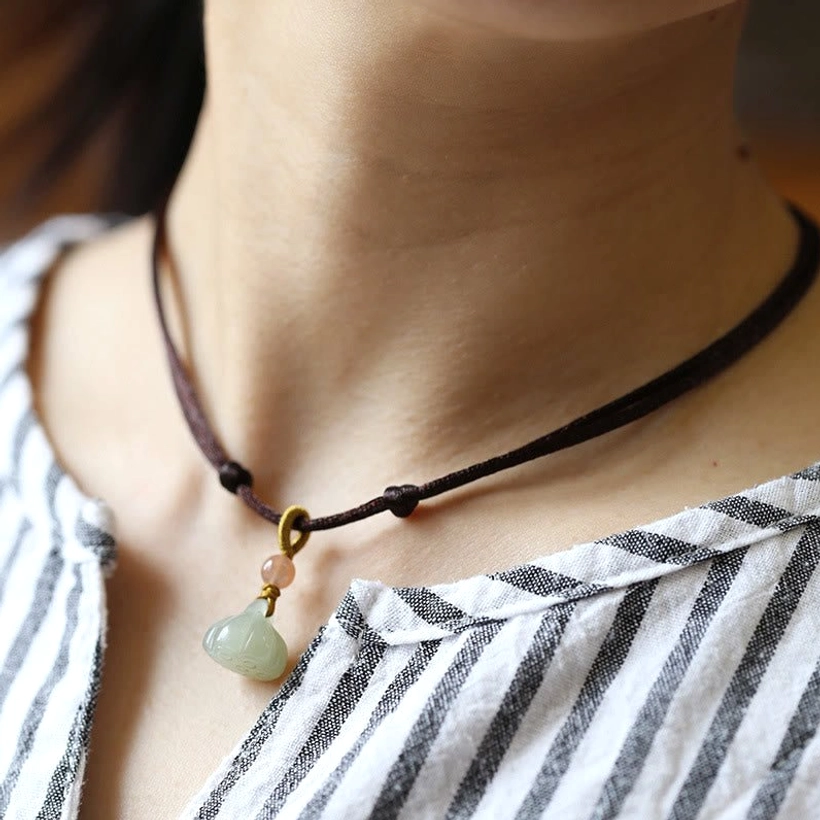 Natural jade lotus pendant necklace in brown wax cord with accent bead