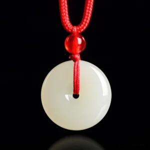 Natural jade peace buckle necklace with red rope pendant on black background - front flat lay view