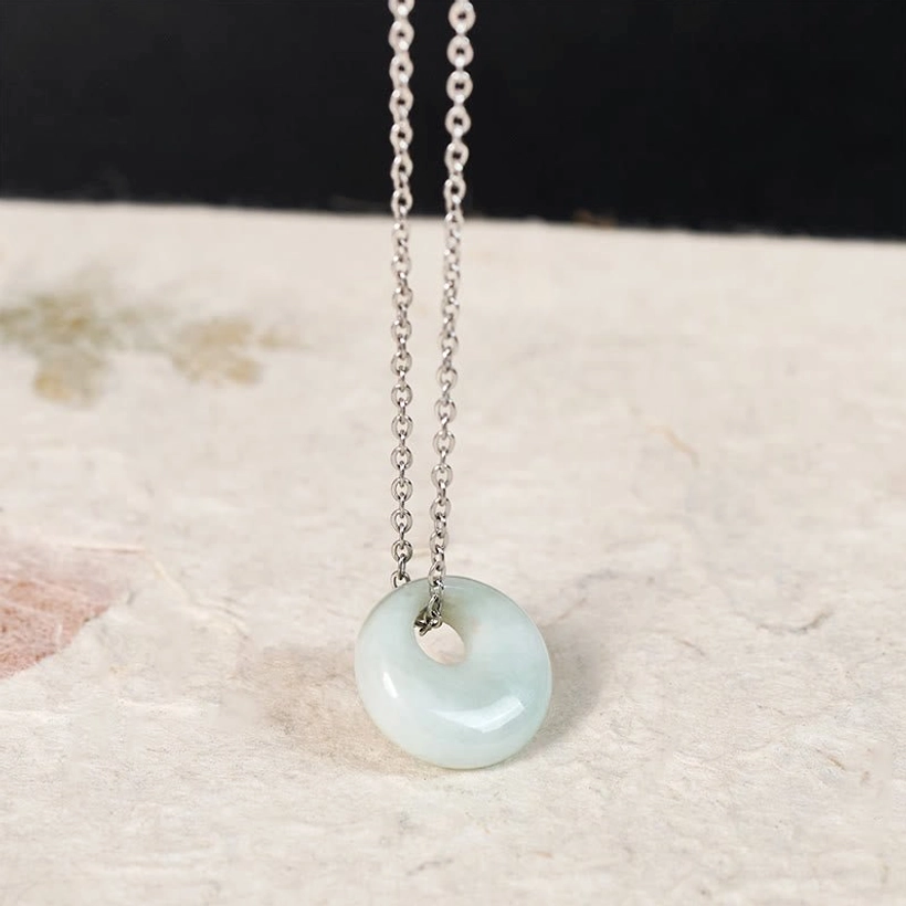 Natural jade round pendant necklace showing stone texture and color variation detail