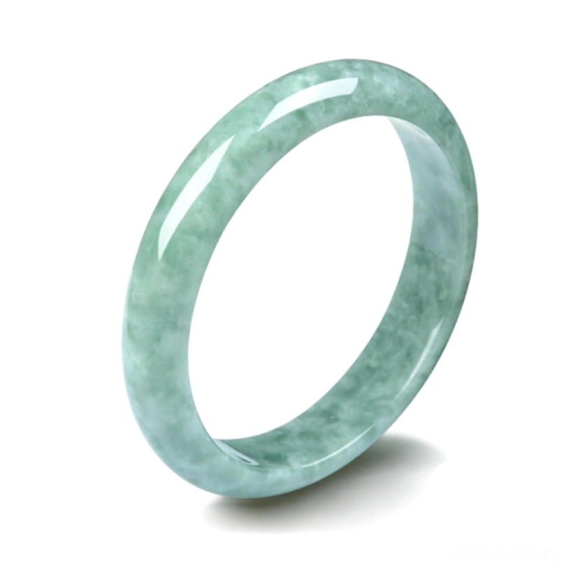 Single natural jade bangle bracelet in three-quarter side view on white background with soft shadow, displaying smooth polished light green jade surface and bangle proportions