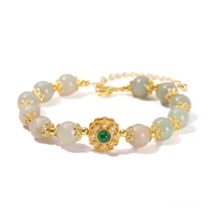 Natural jade prosperity bracelet with 8mm polished jade beads and gold chain clasp on pink background - handmade jade jewelry for abundance