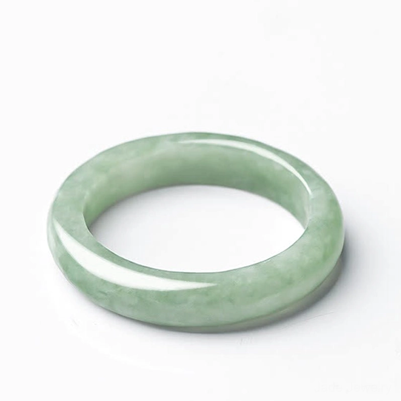 Natural jade prosperity ring front view light green smooth polished finish