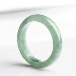 Natural jade prosperity ring handcrafted light green polished band three-quarter view