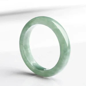 Natural jade prosperity ring handcrafted light green polished band three-quarter view