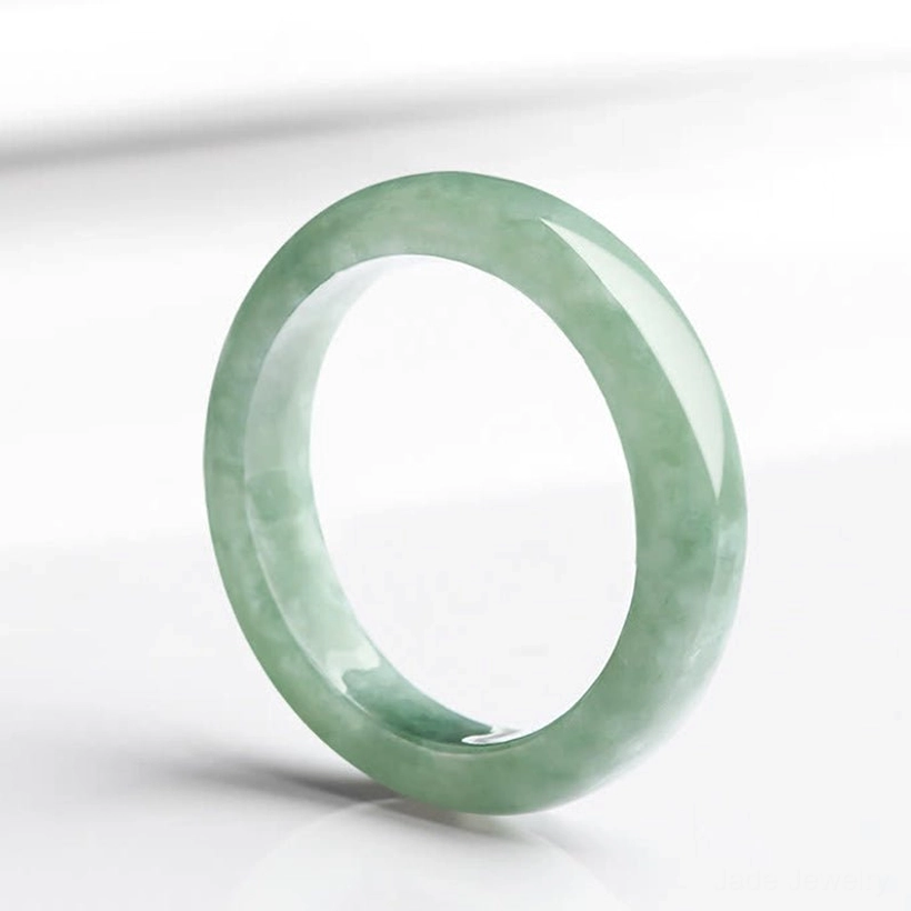 Natural jade prosperity ring handcrafted light green polished band three-quarter view