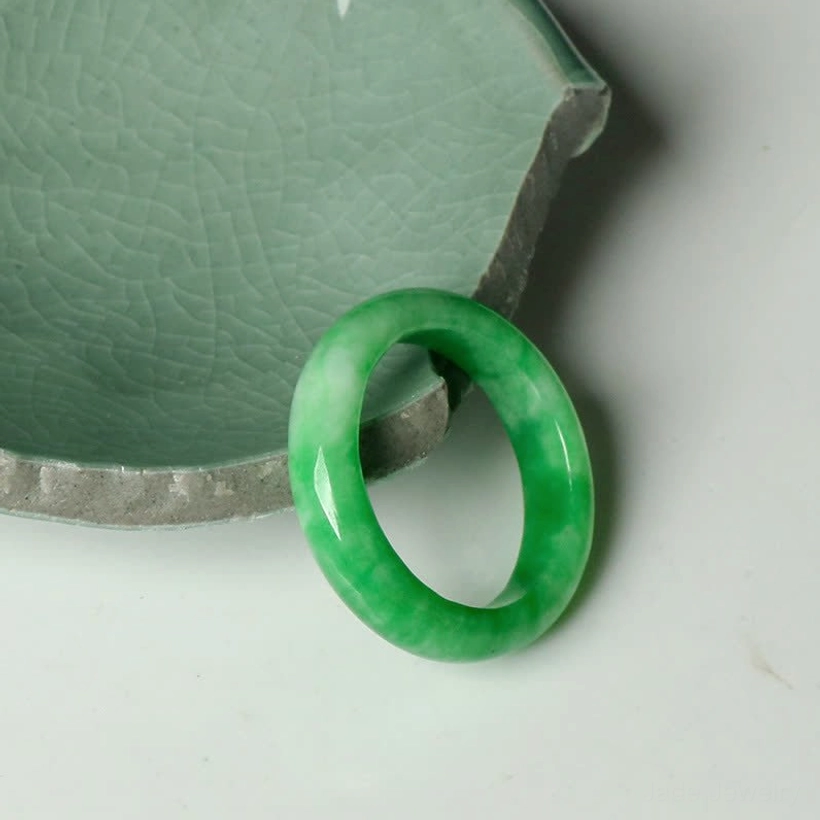 Handmade jade abundance ring deep emerald green three quarter side angle white background