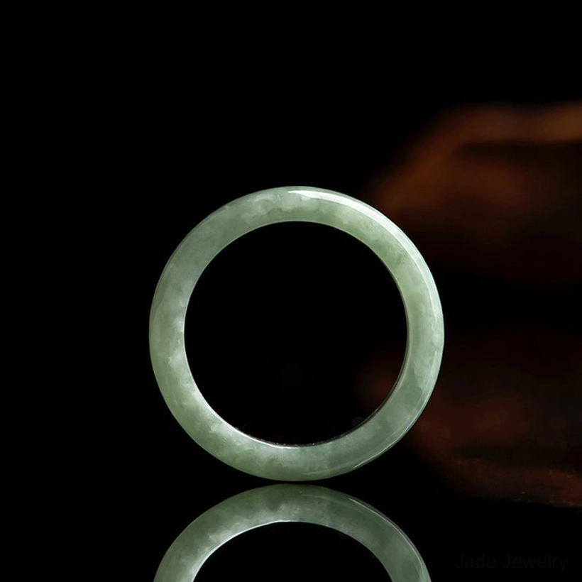 Thin natural jade prosperity ring slim band polished light green reflective studio