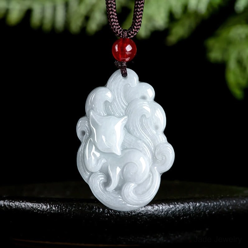 Nine-tailed fox jade pendant carved white jade front view displayed on black stand with natural backdrop