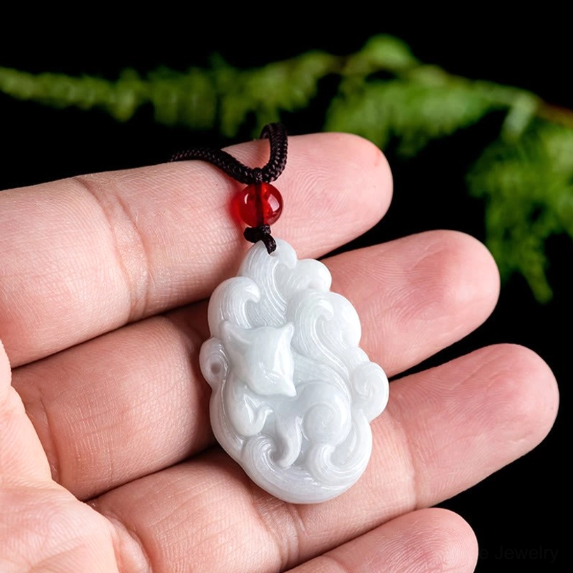 Nine-tailed fox jade pendant held in hand showing actual size and jade quality