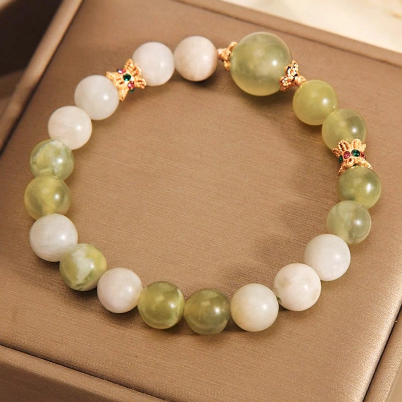 Olive green ombre jade abundance bracelet with gold hardware on neutral background