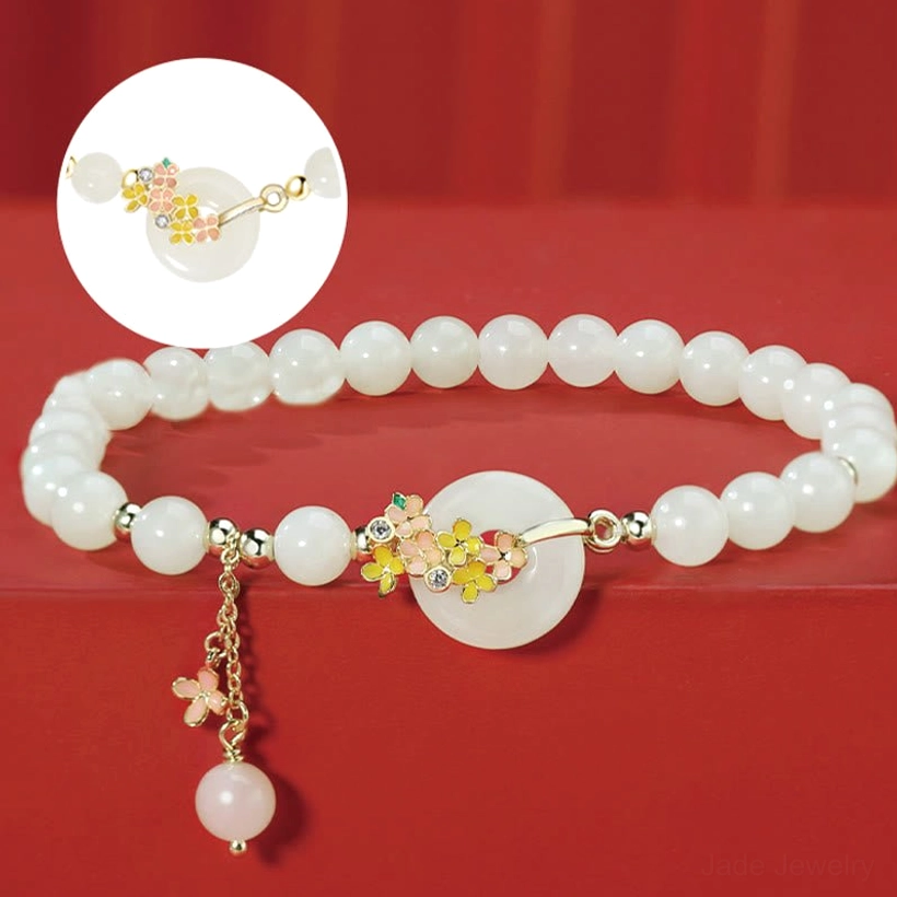 Close-up of osmanthus flower clasp and dangling jade charm on hetian jade bracelet