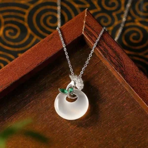 Silver-tone peace buckle chalcedony pendant with green gem leaf accents side view