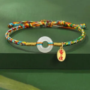 Handmade peace buckle jade bracelet with multicolor woven rope and 925 sterling silver charm, flat lay view