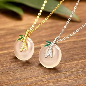 Two matching chalcedony bamboo leaf peace buckle necklaces in sterling silver and gold-plated finishes, side-by-side comparison
