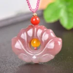 Pink golden silk jade lotus flower pendant necklace front view close-up with decorative red and yellow beads