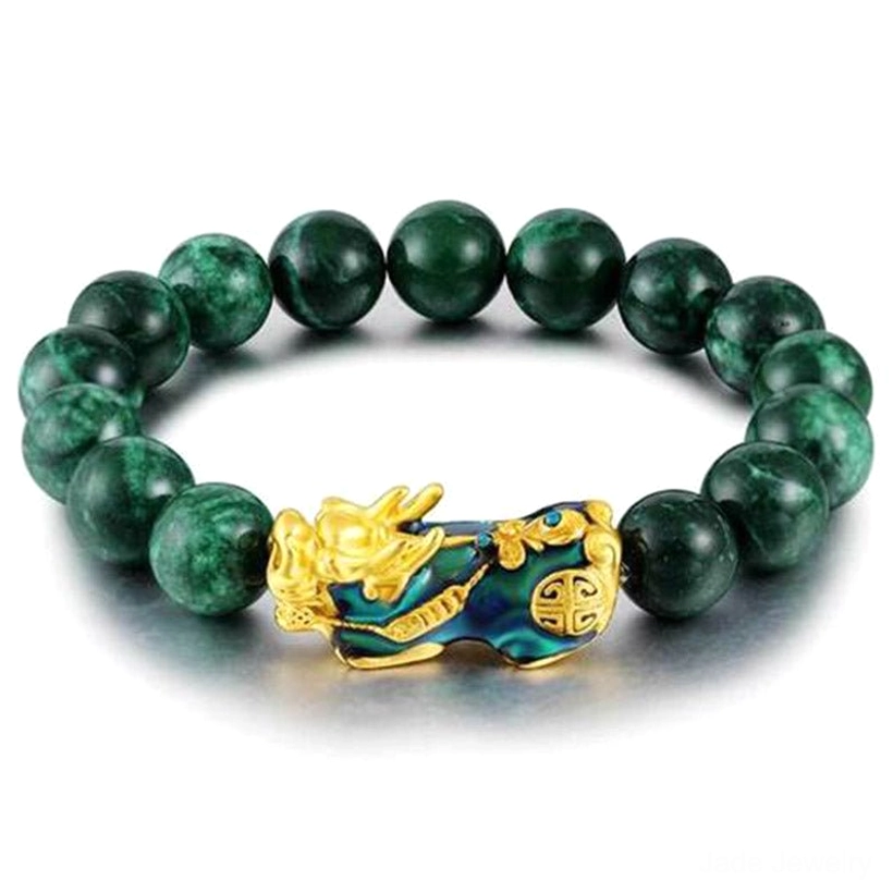 Cyan jade Pixiu bracelet with large gold enamel charm on white studio background