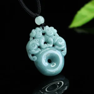 Pixiu jade peace buckle pendant necklace angled perspective showing carved twin Pixiu design in muted teal jade