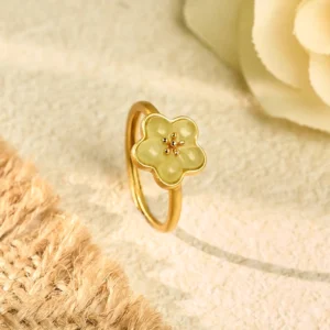 Plum Blossom Hetian Jade Copper Luck Ring - Close-up three-quarter view showing delicate yellow jade flower charm with gold-plated copper band