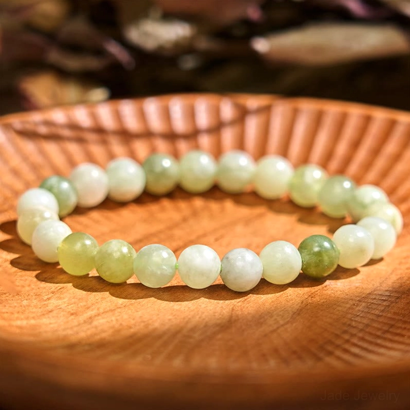 Pure jade green balance bracelet, flat lay display showing smooth polished round jade beads on elastic string