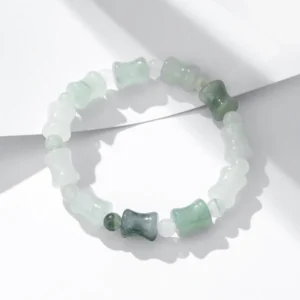 Pure jade bamboo beaded stretch bracelet showing gradient green tones on white background - natural stone prosperity bracelet